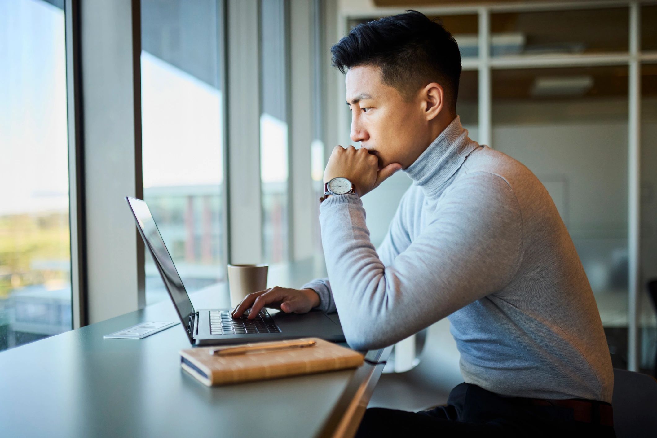 Professional working on a laptop in a modern office