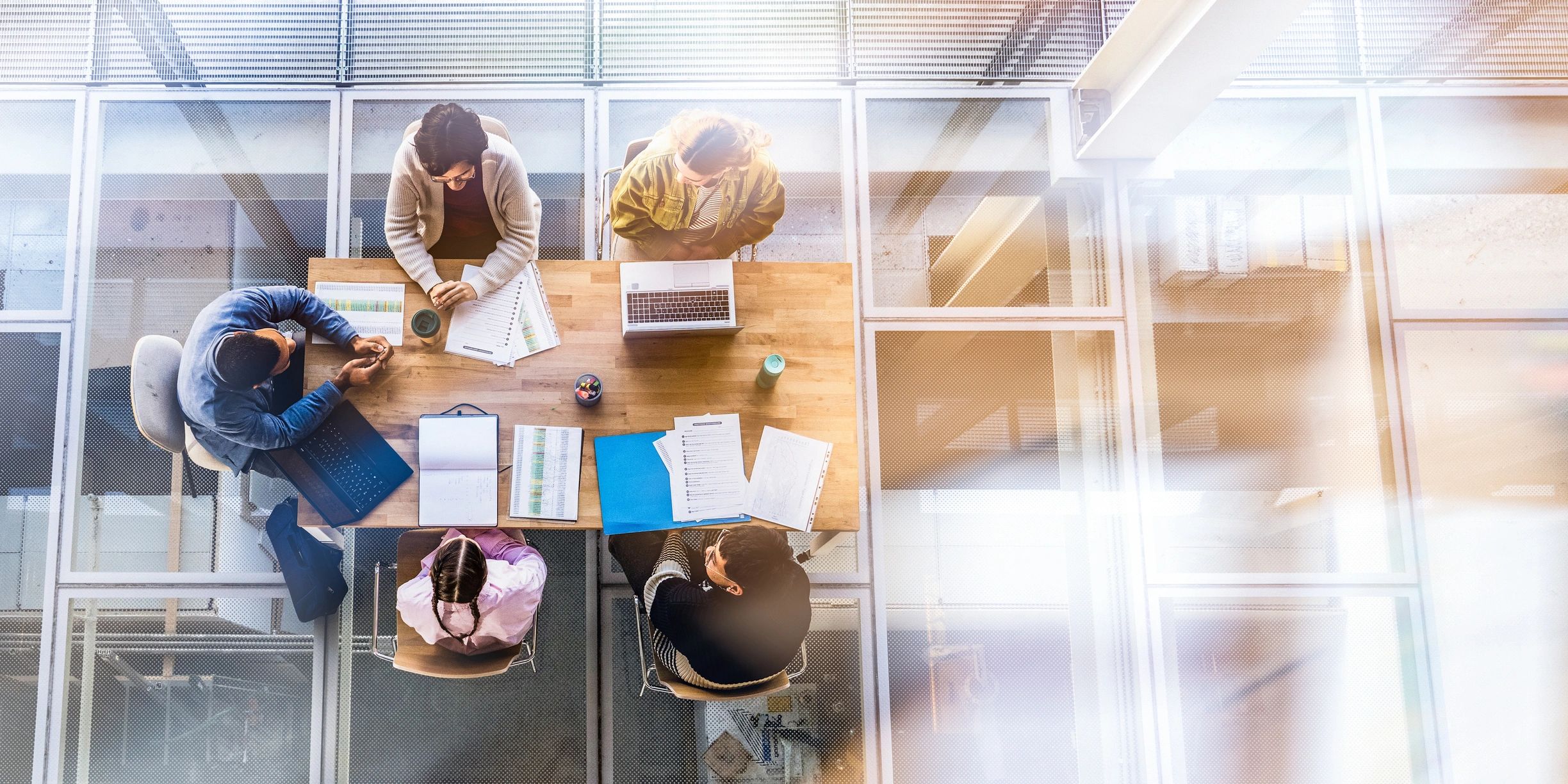 Professionals collaborating around a table in a modern office